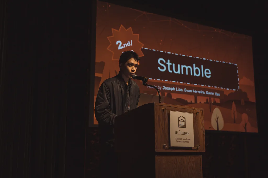 Stumble team pitching at a uOttawa podium at Hack the Hill II