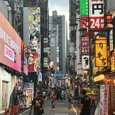 Busy neon-lit street in Shinjuku, Tokyo