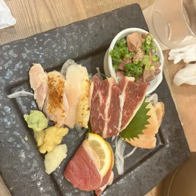 Plate of assorted sashimi with wasabi and lemon