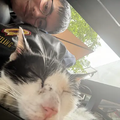 Selfie with a black and white cat in the foreground