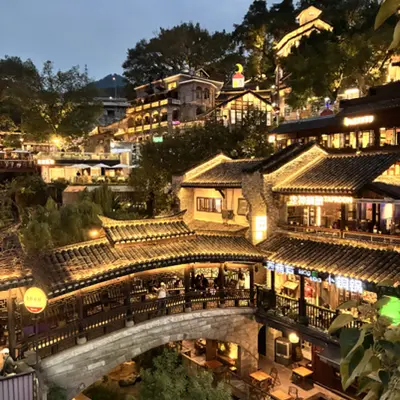 Hillside stilted buildings lit up at night in Chongqing