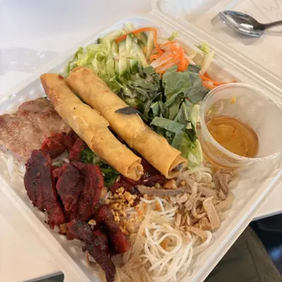 Vermicelli bowl with spring rolls, grilled pork, and herbs