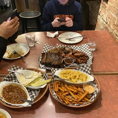 Table of barbecue ribs and sides at a restaurant