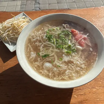 Bowl of noodle soup with sliced beef and bean sprouts